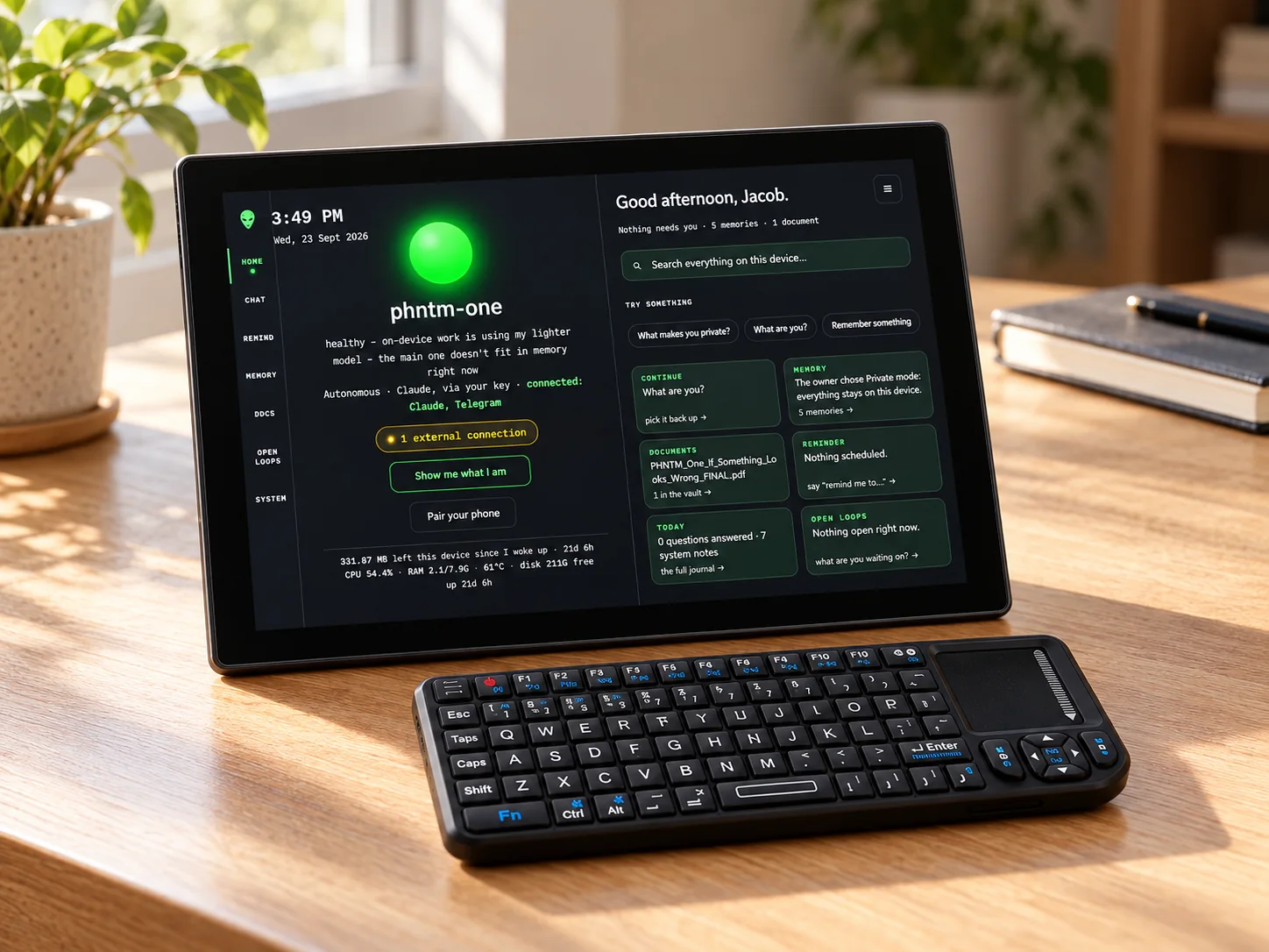 PHNTM One with its mini keyboard on a sunlit desk